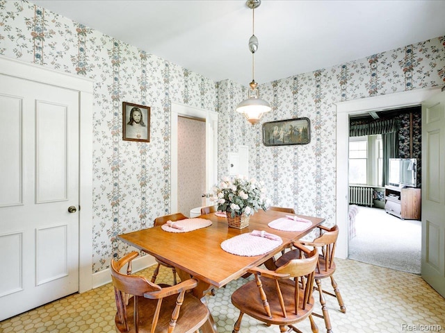 2815 Military St, Fort Gratiot, MI 48060 - dining area with radiator heating unit, wallpapered walls, and light floors