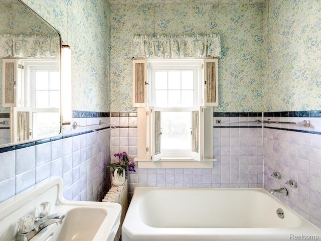 2815 Military St, Fort Gratiot, MI 48060 - bathroom featuring wallpapered walls, a bath, wainscoting, and tile walls