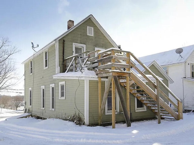 1925 Douglas Ave, Kalamazoo, MI 49007 - snow covered back of property with a chimney and stairs