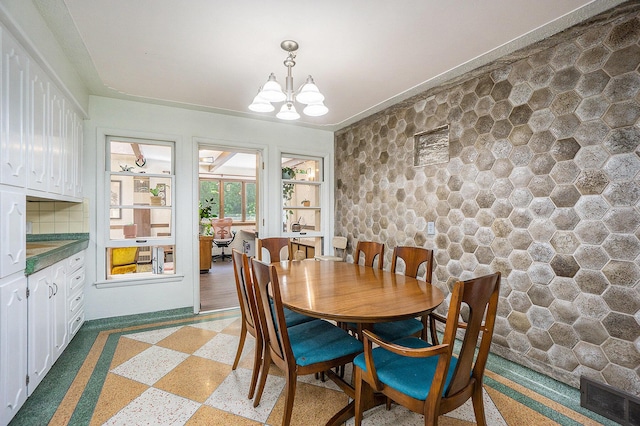 835 Farrell Ave, Kalamazoo, MI 49006 - dining space with dark speckled floor and a chandelier