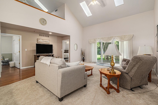 1314 Honeysuckle Ln, Niles, MI 49120 - living area featuring a skylight, high vaulted ceiling, a ceiling fan, and light wood-style floors