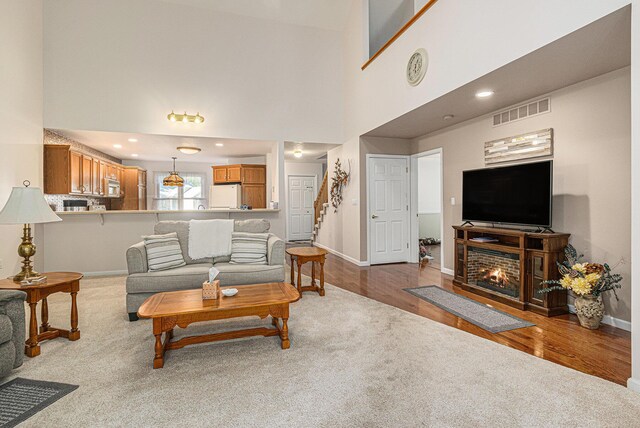 1314 Honeysuckle Ln, Niles, MI 49120 - living room with wood finished floors, stairway, and a towering ceiling