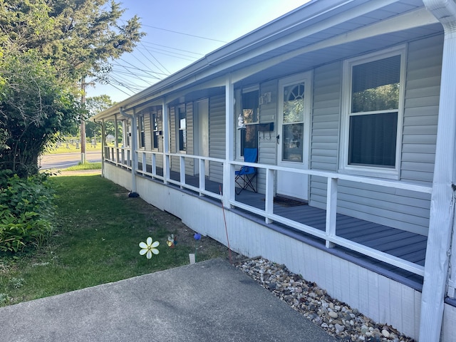 1805 Lakeshore Dr, Saint Joseph, MI 49085 - view of side of home featuring covered porch and a lawn