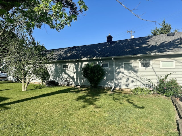 1805 Lakeshore Dr, Saint Joseph, MI 49085 - rear view of property with a yard, a chimney, and roof with shingles
