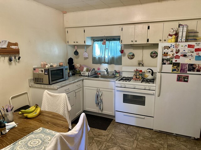 1805 Lakeshore Dr, Saint Joseph, MI 49085 - kitchen with white appliances, white cabinetry, and light countertops