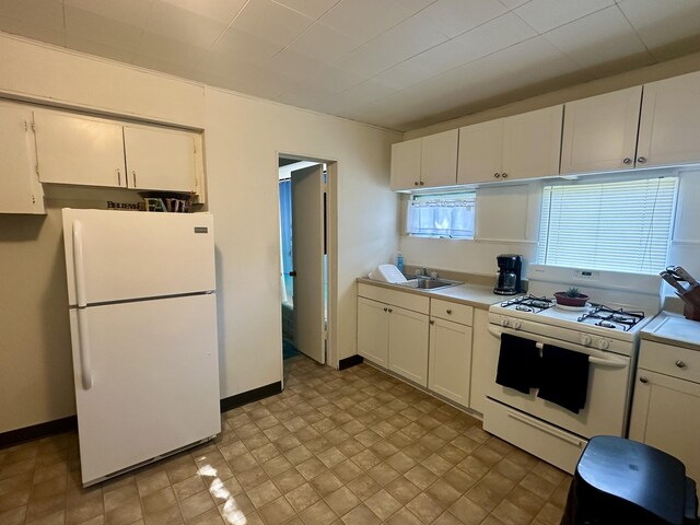 1805 Lakeshore Dr, Saint Joseph, MI 49085 - kitchen with white appliances, light countertops, and white cabinets
