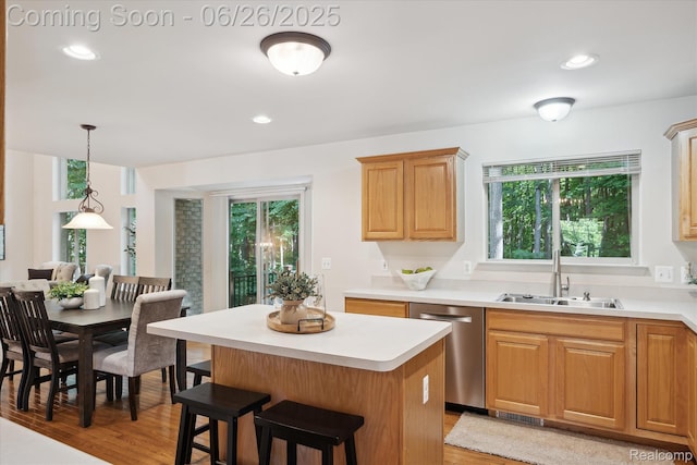 2538 Campbell Ct, Canton, MI 48188 - kitchen featuring dishwasher, light wood-style floors, light countertops, a kitchen island, and a kitchen bar