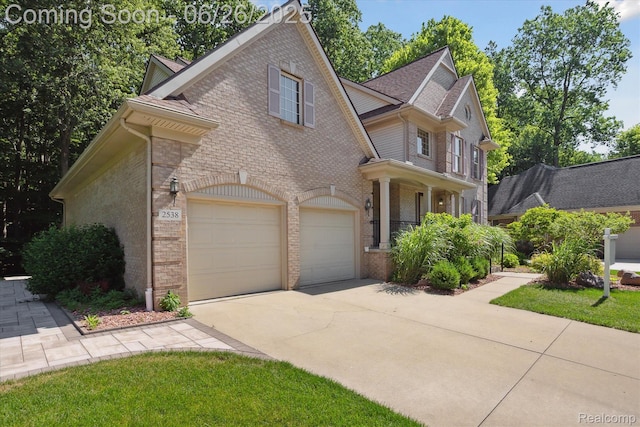 2538 Campbell Ct, Canton, MI 48188 - view of front facade with concrete driveway, brick siding, stone siding, and roof with shingles