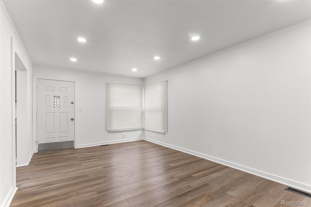 1085 Pennsylvania Ave, Lincoln Park, MI 48146 - empty room featuring dark wood-style flooring, recessed lighting, and ornamental molding