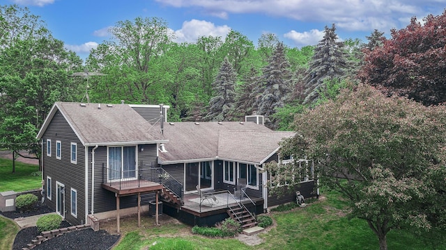 7640 W H Ave, Kalamazoo, MI 49009 - back of house with a deck, a shingled roof, and a yard