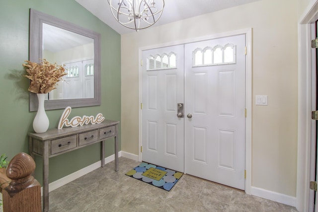 7640 W H Ave, Kalamazoo, MI 49009 - entrance foyer featuring a chandelier and baseboards