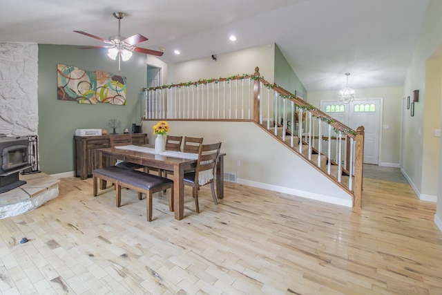 7640 W H Ave, Kalamazoo, MI 49009 - dining area with a wood stove, stairs, a chandelier, recessed lighting, and wood finished floors