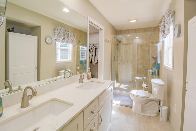 7640 W H Ave, Kalamazoo, MI 49009 - full bath featuring a shower stall, double vanity, a spacious closet, tile patterned flooring, and recessed lighting