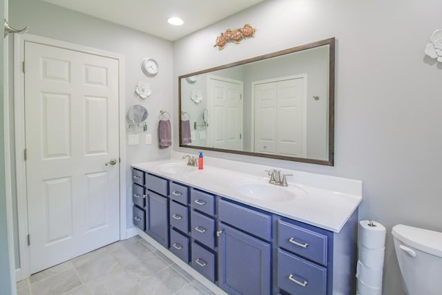 7640 W H Ave, Kalamazoo, MI 49009 - bathroom with double vanity and toilet