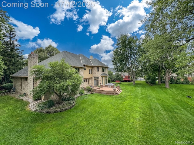 4532 Franklin Mill Rd, Southfield, MI 48301 - back of property featuring a yard, a chimney, stone siding, a patio, and brick siding