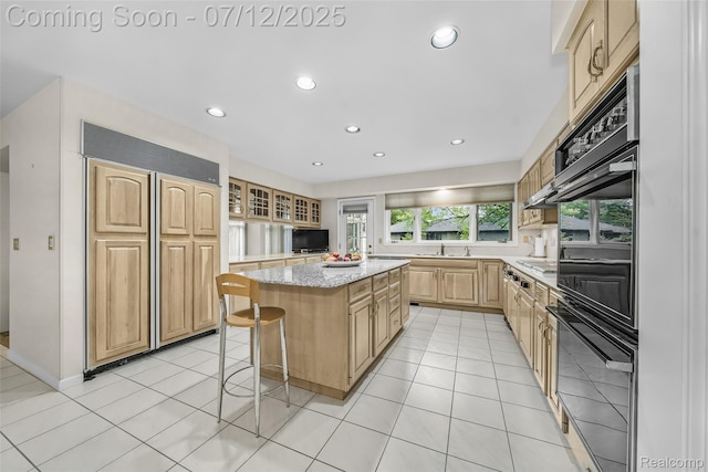 4532 Franklin Mill Rd, Southfield, MI 48301 - kitchen with paneled built in refrigerator, a kitchen island, a breakfast bar, light brown cabinetry, and light stone countertops