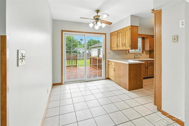 2295 Plainview Dr, Saginaw, MI 48603 - kitchen featuring light countertops, a ceiling fan, light tile patterned flooring, and a peninsula
