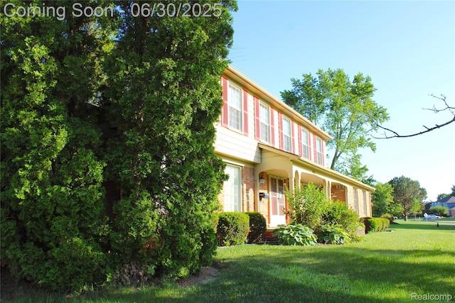 486 Charing Cross Dr, Grand Blanc, MI 48439 - view of front of home with a front yard and brick siding