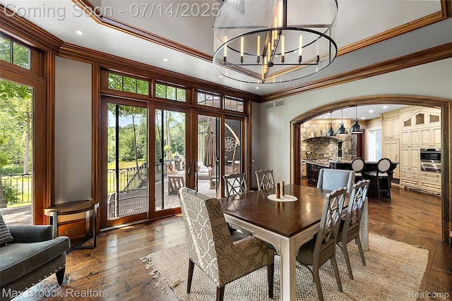 7420 Inner Circle Dr, Bloomfield Hills, MI 48301 - dining room with hardwood / wood-style floors, crown molding, french doors, arched walkways, and a chandelier