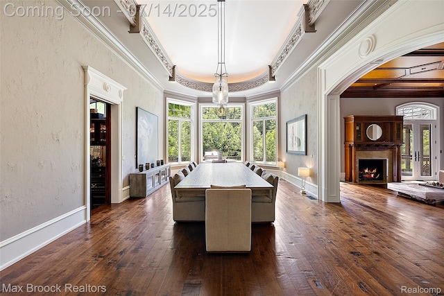 7420 Inner Circle Dr, Bloomfield Hills, MI 48301 - dining room featuring crown molding, plenty of natural light, dark wood-style flooring, a lit fireplace, and arched walkways