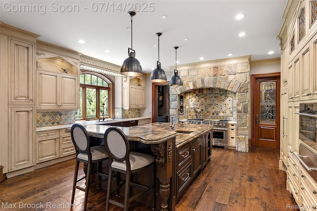 7420 Inner Circle Dr, Bloomfield Hills, MI 48301 - kitchen featuring appliances with stainless steel finishes, ornamental molding, decorative backsplash, cream cabinets, and a kitchen breakfast bar