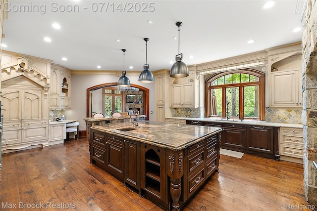 7420 Inner Circle Dr, Bloomfield Hills, MI 48301 - kitchen featuring cream cabinetry, dark brown cabinetry, dark wood-type flooring, recessed lighting, and crown molding