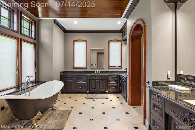 7420 Inner Circle Dr, Bloomfield Hills, MI 48301 - bathroom featuring two vanities, a freestanding tub, ornamental molding, tile patterned floors, and recessed lighting