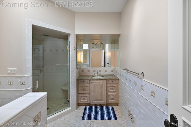 7420 Inner Circle Dr, Bloomfield Hills, MI 48301 - bathroom with tile walls, vanity, a shower stall, wainscoting, and tile patterned floors