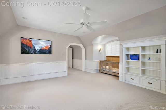 7420 Inner Circle Dr, Bloomfield Hills, MI 48301 - unfurnished room with carpet, ceiling fan, wainscoting, arched walkways, and vaulted ceiling