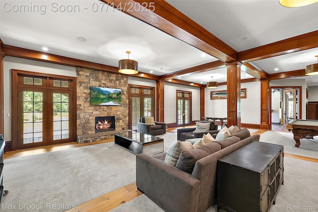 7420 Inner Circle Dr, Bloomfield Hills, MI 48301 - living area with french doors, beam ceiling, decorative columns, recessed lighting, and a stone fireplace