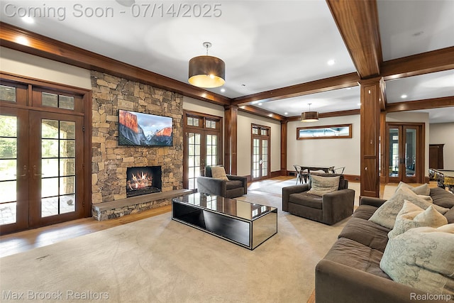 7420 Inner Circle Dr, Bloomfield Hills, MI 48301 - living area with french doors, crown molding, healthy amount of natural light, beamed ceiling, and a stone fireplace
