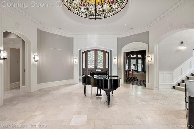 7420 Inner Circle Dr, Bloomfield Hills, MI 48301 - entryway featuring french doors, arched walkways, a high ceiling, stone tile flooring, and stairs