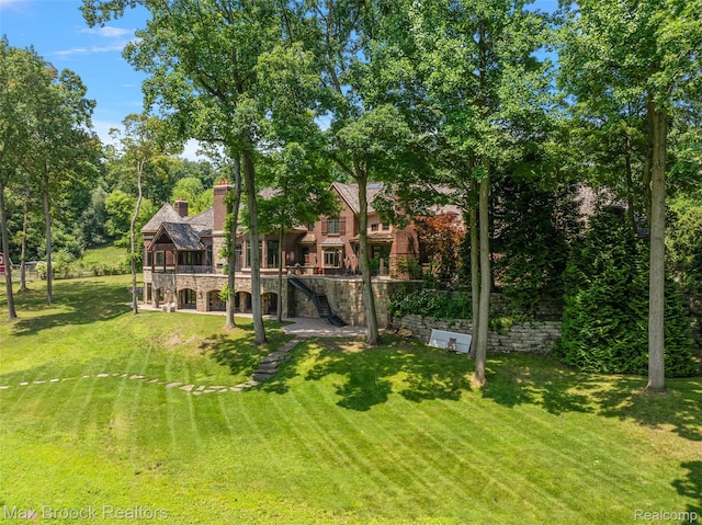 7420 Inner Circle Dr, Bloomfield Hills, MI 48301 - view of grassy yard with stairs and a wooden deck