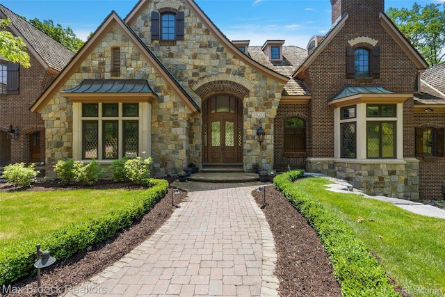7420 Inner Circle Dr, Bloomfield Hills, MI 48301 - english style home featuring french doors, a standing seam roof, stone siding, and a chimney