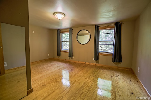 4176 Kings Corner Rd, Glennie, MI 48737 - spare room featuring light wood-style floors and plenty of natural light
