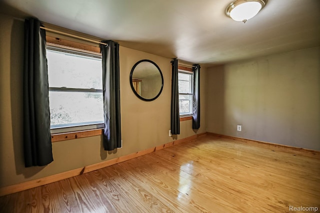 4176 Kings Corner Rd, Glennie, MI 48737 - spare room featuring light wood-type flooring and baseboards