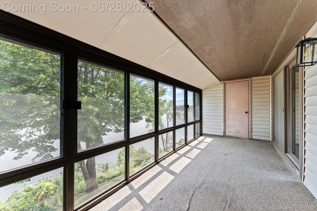 510 Cliffs Dr Unit 305, Ypsilanti, MI 48197 - unfurnished sunroom featuring vaulted ceiling and a water view