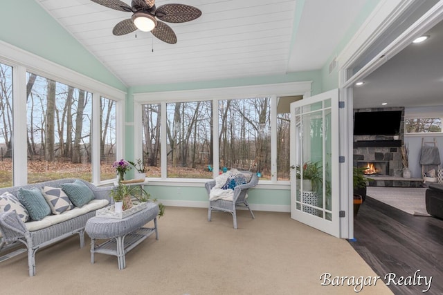 8790 Laurel Ridge Dr SE, Alto, MI 49302 - sunroom featuring lofted ceiling, ceiling fan, and a stone fireplace