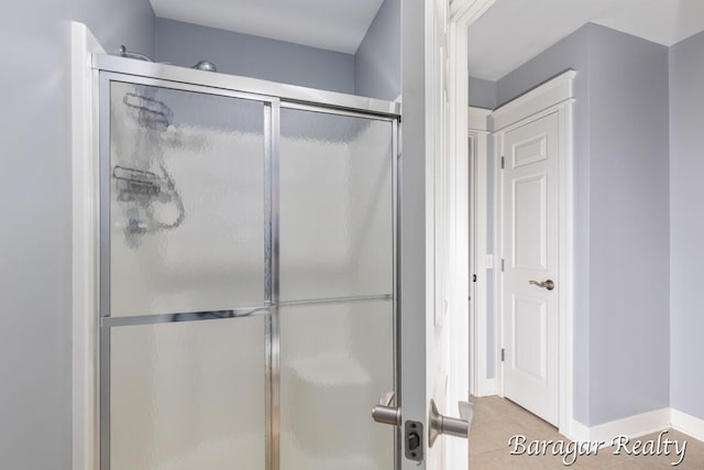 8790 Laurel Ridge Dr SE, Alto, MI 49302 - bathroom featuring a shower with door and tile patterned floors