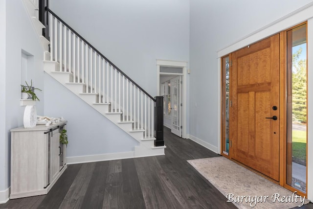 8790 Laurel Ridge Dr SE, Alto, MI 49302 - foyer entrance featuring a towering ceiling, dark wood finished floors, and stairs