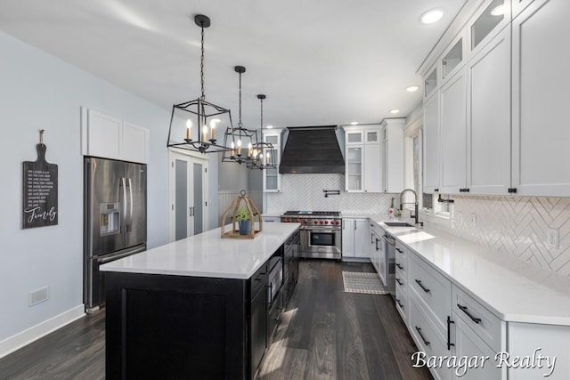 8790 Laurel Ridge Dr SE, Alto, MI 49302 - kitchen with appliances with stainless steel finishes, premium range hood, dark wood finished floors, a kitchen island, and decorative backsplash
