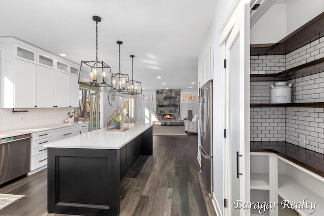 8790 Laurel Ridge Dr SE, Alto, MI 49302 - kitchen featuring tasteful backsplash, stainless steel appliances, open floor plan, a chandelier, and recessed lighting