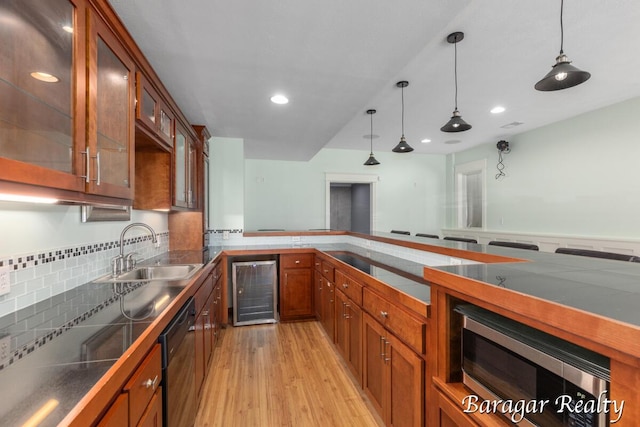 8790 Laurel Ridge Dr SE, Alto, MI 49302 - kitchen with beverage cooler, dishwasher, stainless steel microwave, brown cabinets, and recessed lighting