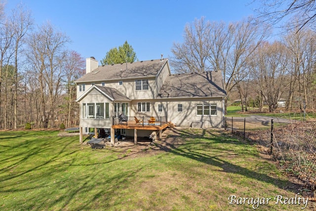8790 Laurel Ridge Dr SE, Alto, MI 49302 - back of property featuring a wooden deck, a chimney, and a sunroom
