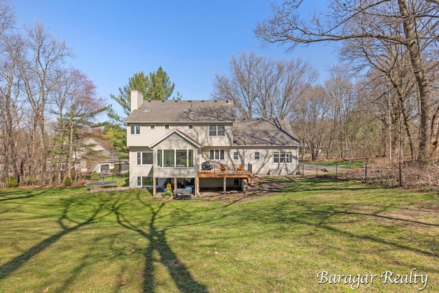 8790 Laurel Ridge Dr SE, Alto, MI 49302 - back of property featuring a deck, a chimney, and a sunroom