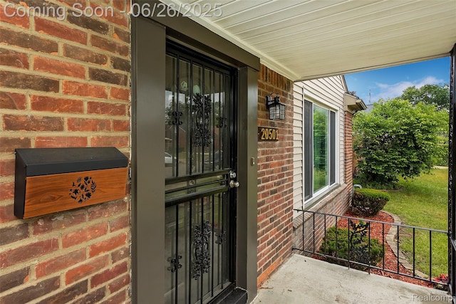 20501 Stout St, Detroit, MI 48219 - view of exterior entry featuring brick siding and a porch
