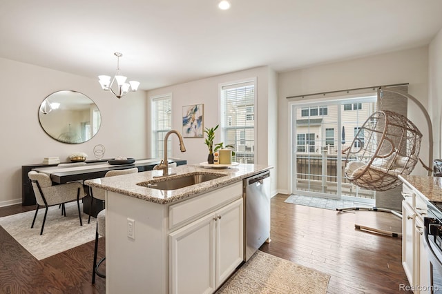 2855 Hardwick Rd, Ann Arbor, MI 48105 - kitchen with dishwasher, light stone counters, dark wood finished floors, a chandelier, and hanging light fixtures