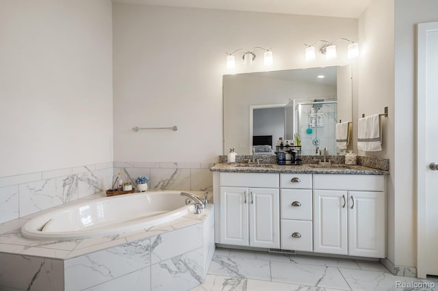 2855 Hardwick Rd, Ann Arbor, MI 48105 - bathroom featuring a stall shower, double vanity, a garden tub, and marble finish flooring