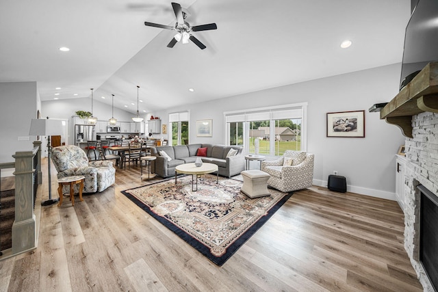 14170 Spring Valley Ct, Niles, MI 49120 - living area featuring vaulted ceiling, a fireplace, ceiling fan, light wood-style flooring, and recessed lighting