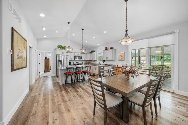 14170 Spring Valley Ct, Niles, MI 49120 - dining room with light wood-style flooring, recessed lighting, and high vaulted ceiling